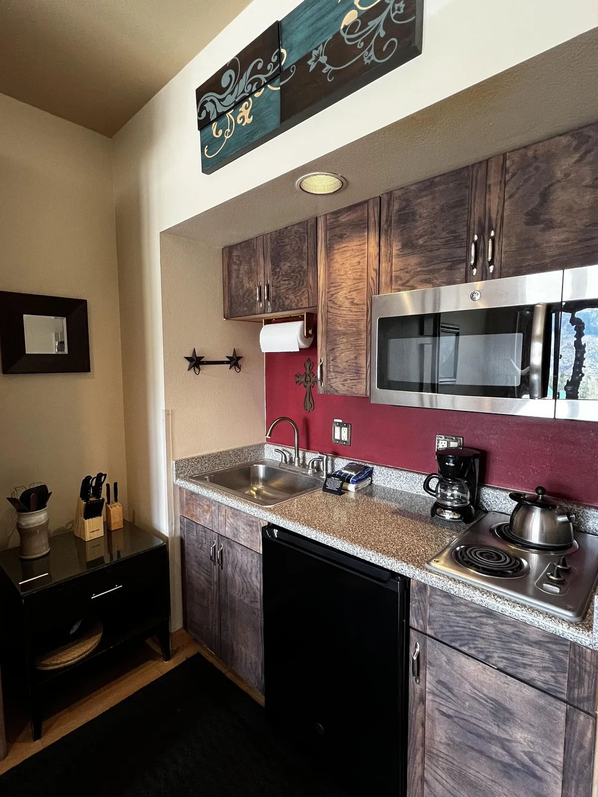A practical kitchen with ample cabinetry, modern appliances, and decorative artwork, designed for cooking and socializing. The space is ideal for preparing meals, hosting brunch, or sharing recipes, fostering the sense of convenience and togetherness.
